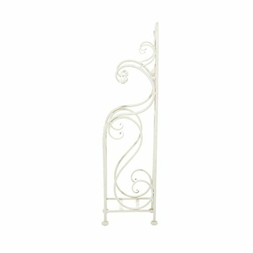 Side view of a decorative white metal shelf with scrollwork design.