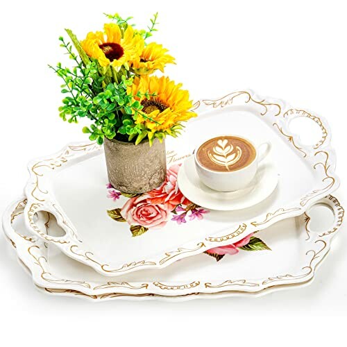 Two decorative serving trays with floral design, coffee cup, and vase with sunflowers