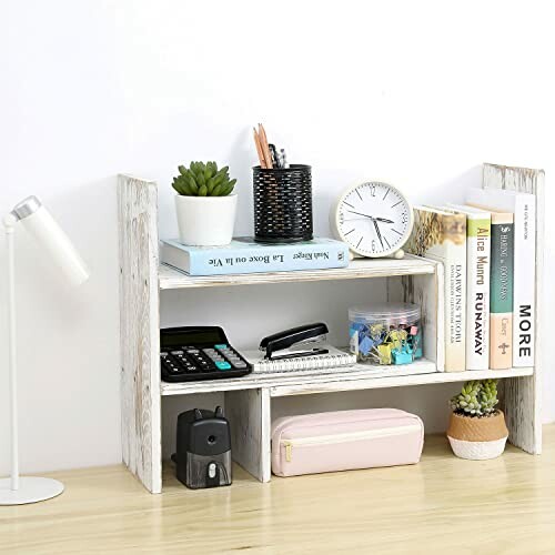 Wooden desk organizer with books, plants, clock, and stationery.