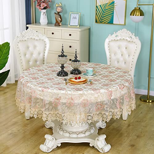 Elegant dining table set with two ornate chairs and decorative items.