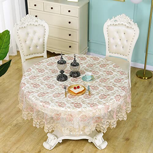 Elegant dining table with lace tablecloth, two chairs, and ornate decorations.