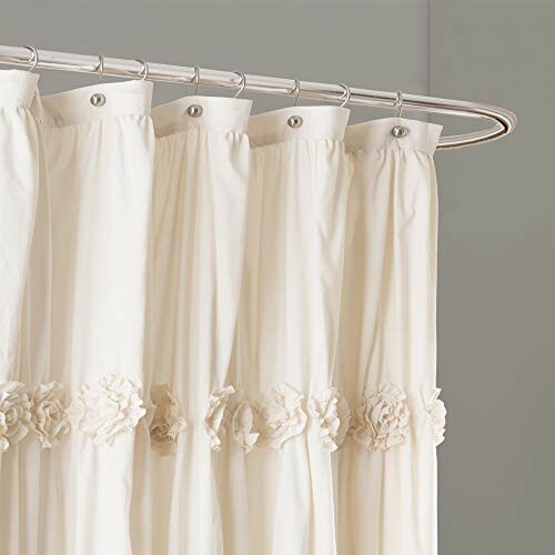 Elegant white shower curtain with decorative ruffles.