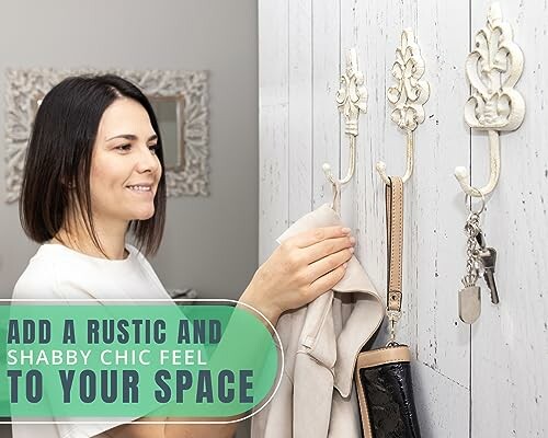 Woman hanging items on decorative rustic wall hooks.