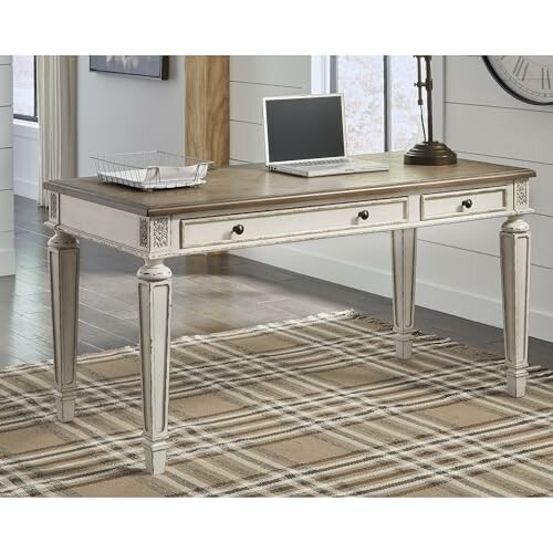 Vintage wooden desk with laptop and tray.