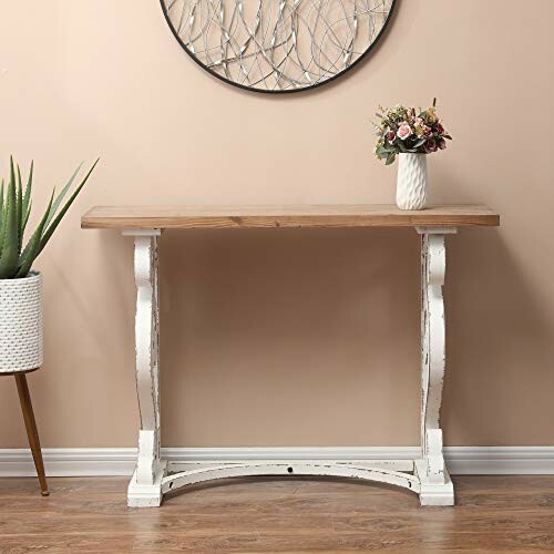 Wooden console table with a vase of flowers and a plant.